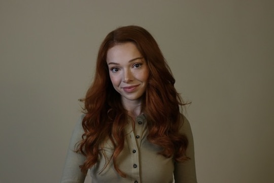 Courtney Sardana in a warm commercial headshot