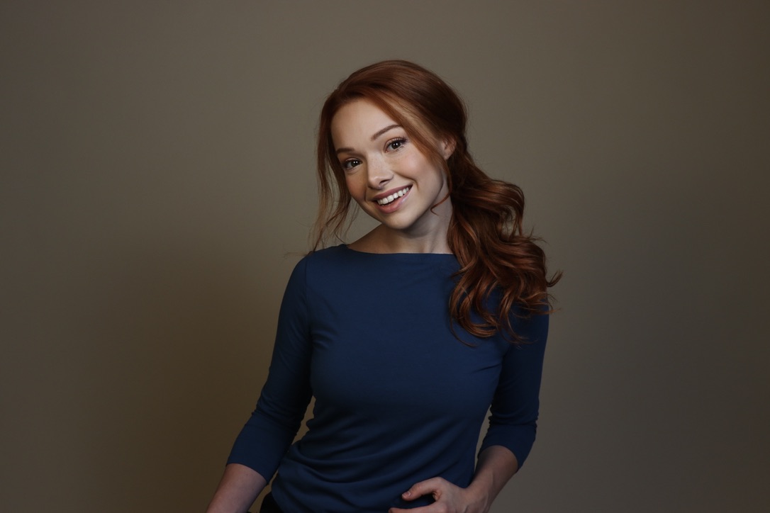 Courtney Sardana smiling in a blue top